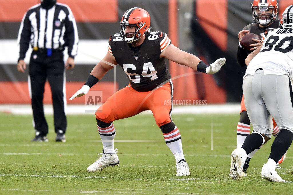 David Richard FILE - In this Sunday, Nov. 1, 2020, file photo, Cleveland Browns center JC Tretter (64) blocks during an NFL football game against the Las Vegas Raiders in Cleveland. Browns center JC Tretter, president of the players' union, has called for all NFL stadiums to put in natural grass fields; this season, 17 stadiums have it, while 13 have synthetic surfaces. (AP Photo/David Richard, File)