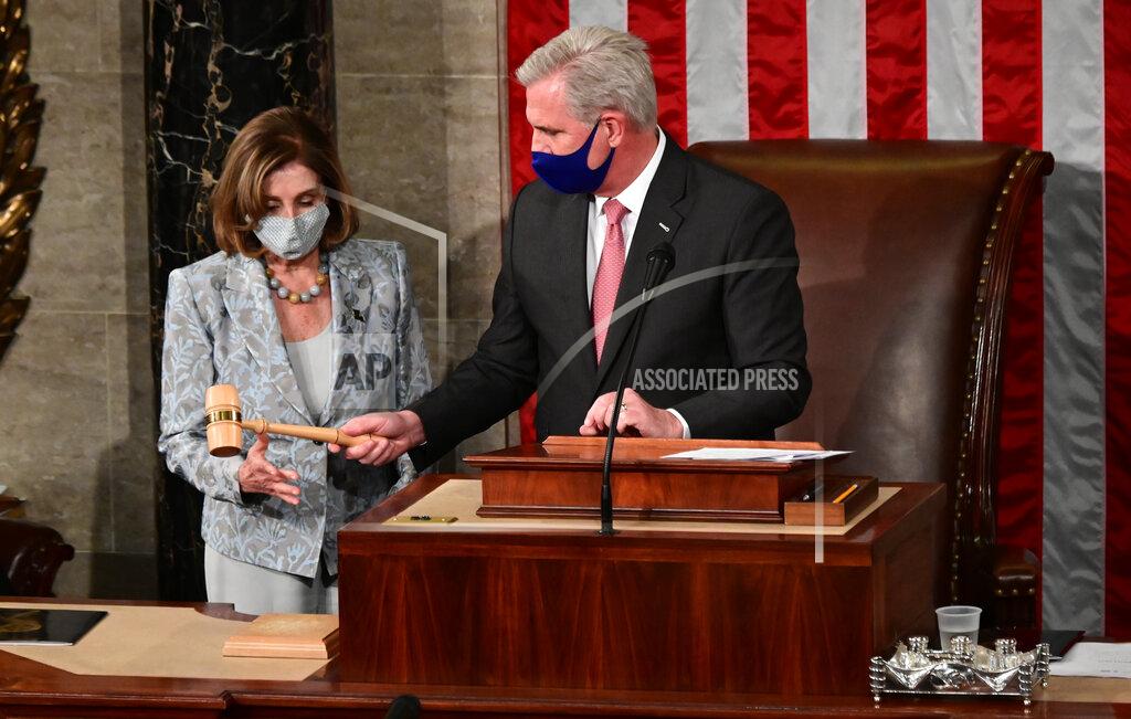 Erin Scott Speaker of the House Nancy Pelosi is handed the Speaker's gavel by House Minority Leader Kevin McCarthy, R-Calif., on the opening day of the 117th Congress on Capitol Hill in Washington, Sunday, Jan. 3, 2021. (Erin Scott/Pool via AP)