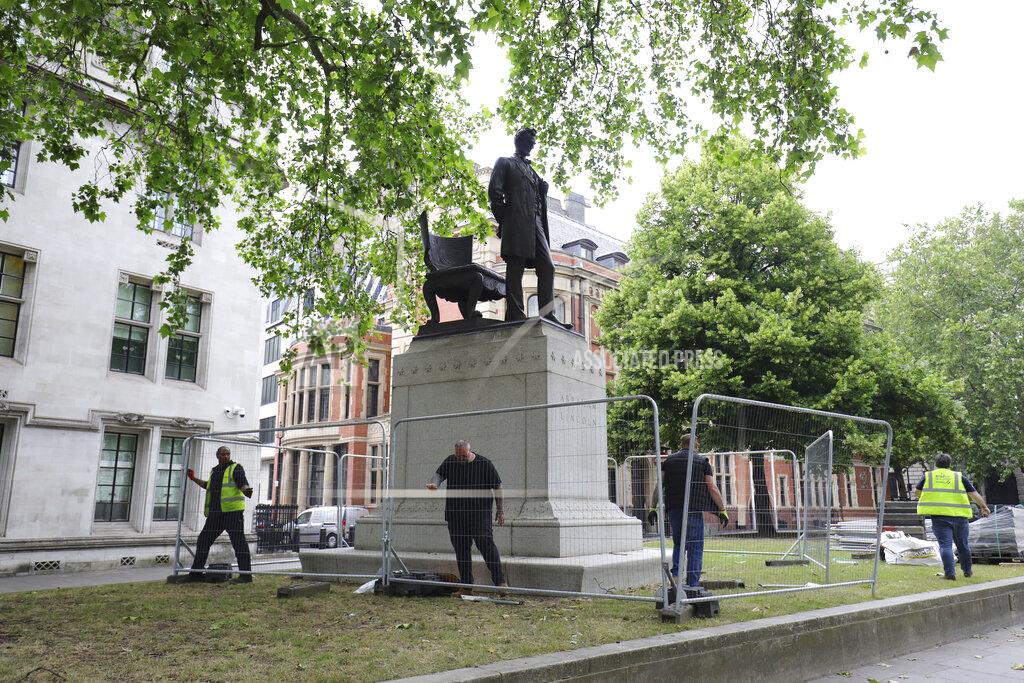 Aaron Chown Barriers are erected around the statue of former US President Abraham Lincoln in Parliament Square, London, Friday June 12, 2020. A raft of Black Lives Matter protests sparked by the death of George Floyd, who was killed recently while in police custody in the US city of Minneapolis, has prompted authorities to protect statues of historical figures who had links to the slave trade, and a wider debate about issues relating to Britain's colonial past. (Aaron Chown/PA via AP)