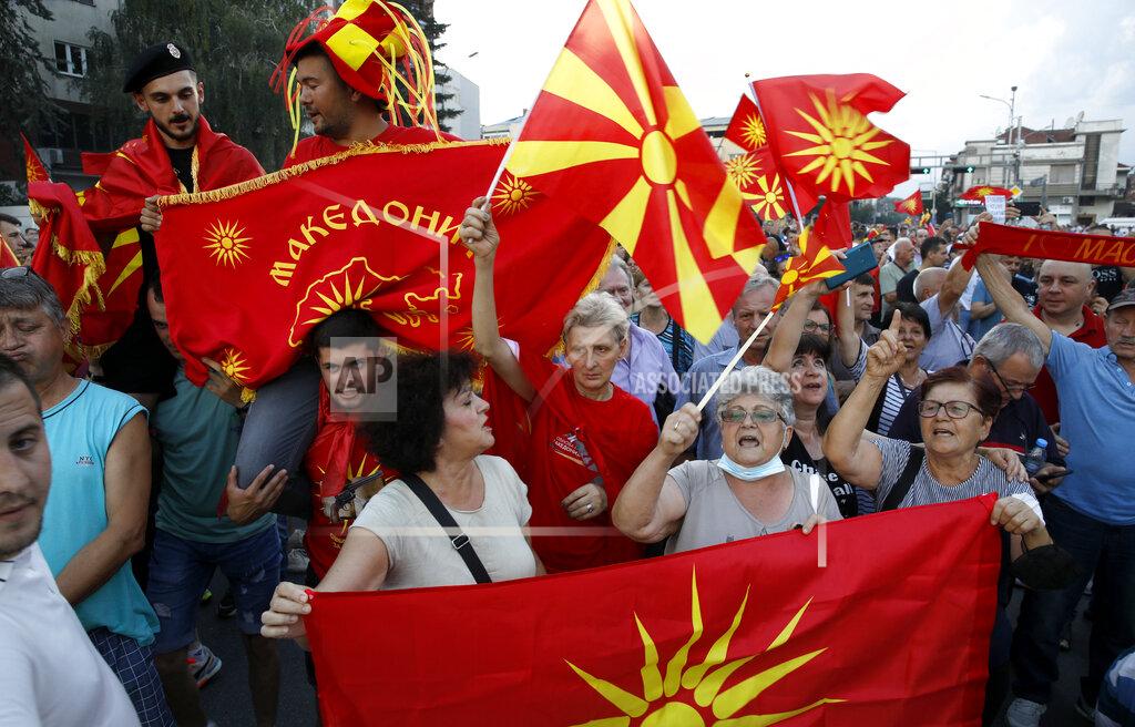 Boris Grdanoski People wave the old and current national flags during a protest in front of the government building in Skopje, North Macedonia, on Saturday, July 2, 2022. Tens of thousands of people gathered late Saturday outside government offices in North Macedonia’s capital to protest the latest proposal on solving a dispute with Bulgaria in order for North Macedonia to open membership talks with the European Union. (AP Photo/Boris Grdanoski)