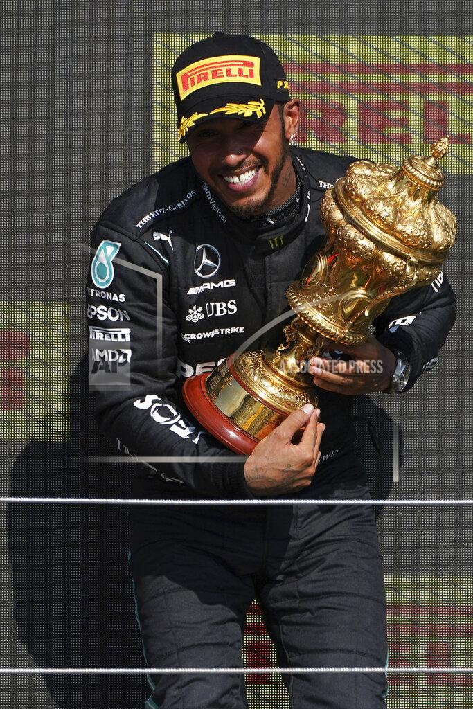 Jon Super Mercedes driver Lewis Hamilton of Britain celebrates on the podium after winning the British Formula One Grand Prix, at the Silverstone circuit, in Silverstone, England, Sunday, July 18, 2021. (AP Photo/Jon Super)