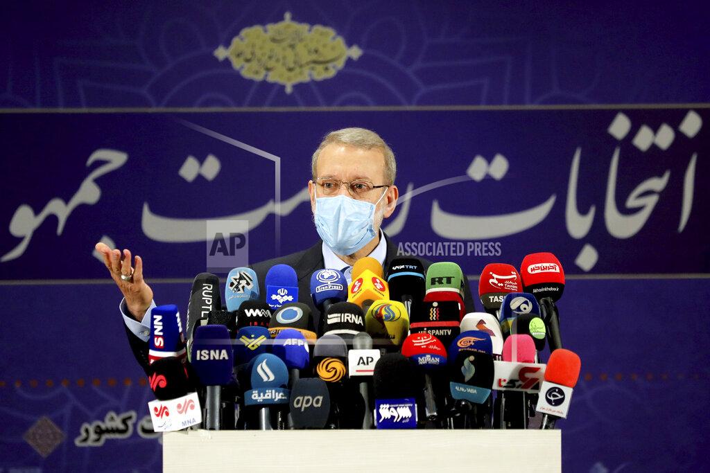 Ebrahim Noroozi Former Iranian parliament speaker Ali Larijani attends a news conference after registering his candidacy for the June 18 presidential elections at the elections headquarters of the Interior Ministry in Tehran, Iran, Saturday, May 15, 2021. (AP Photo/Ebrahim Noroozi)