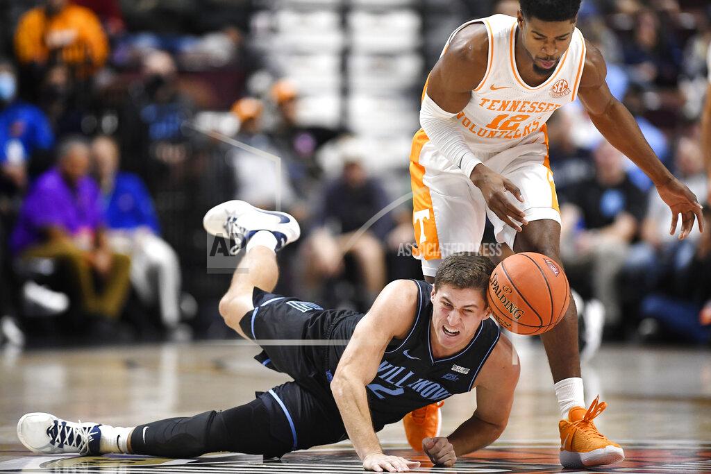 Jessica Hill Villanova's Collin Gillespie (2) and Tennessee's Victor Bailey Jr. (12) battle for a loose ball in the first half of an NCAA college basketball game, Saturday, Nov. 20, 2021, in Uncasville, Conn. (AP Photo/Jessica Hill)