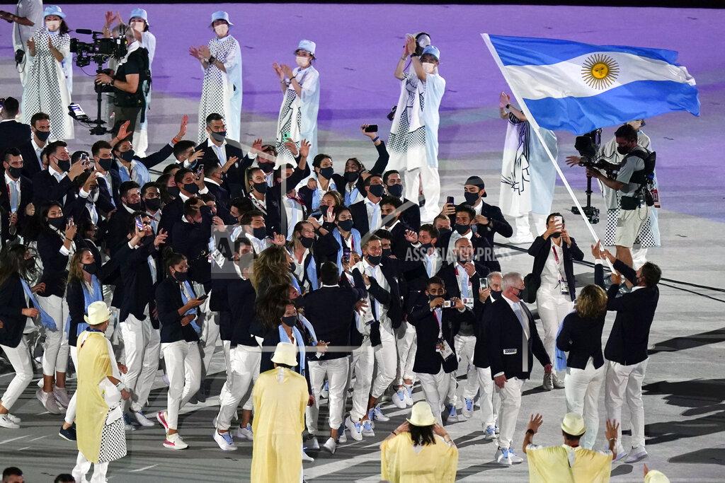 Patrick Semansky Cecilia Carranza Saroli and Santiago Raul Lange, of Argentina, right, carry their country's flag during the opening ceremony in the Olympic Stadium at the 2020 Summer Olympics, Friday, July 23, 2021, in Tokyo, Japan. (AP Photo/Patrick Semansky)