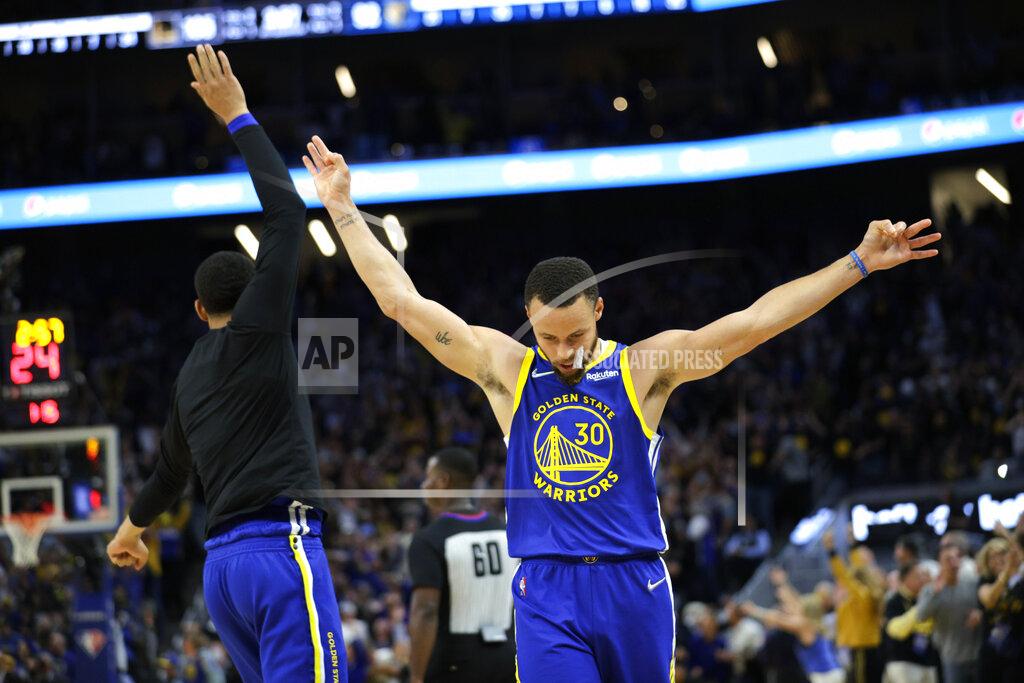 Carlos Avila Gonzalez Golden State Warriors' Stephen Curry (30) celebrates a 3-pointer by Klay Thompson during the second half against the Memphis Grizzlies in Game 6 of the Western Conference semifinals of the NBA basketball playoffs in San Francisco on Friday, May 13, 2022. The Warriors defeated the Grizzlies 110-96 to advance to the conference finals. (Carlos Avila Gonzalez/San Francisco Chronicle via AP)