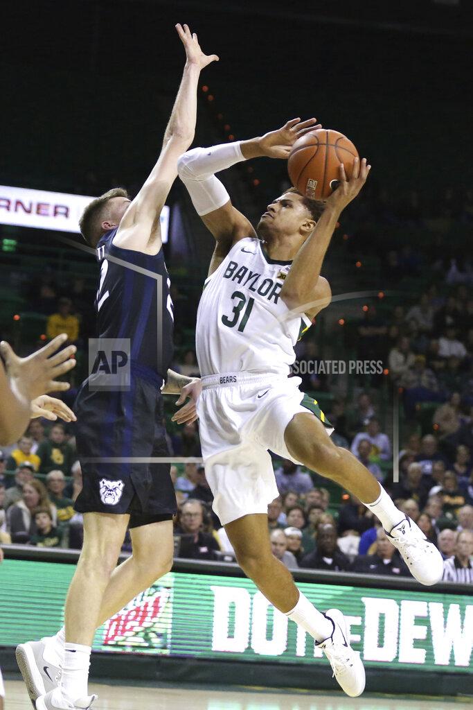 Rod Aydelotte FLE - In this Dec. 10, 2019, file photo, Baylor guard MaCio Teague shoots over Butler forward Sean McDermott, left, in the first half of an NCAA college basketball game in Waco, Texas. Baylor All-Big 12 guard Jared Butler announced his intentions to enter his name into the NBA draft pool while keeping open his options to return to the Bears for his junior season, Monday, April 20, 2020. Teague announced his decision to enter the draft last month. (AP Photo/Rod Aydelotte, File)
