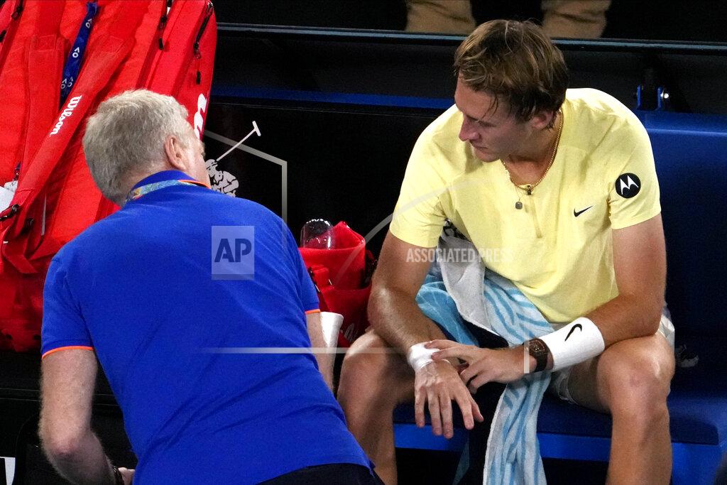Ng Han Guan Sebastian Korda of the U.S. talks with medical staff after having his wrist taped during his quarterfinal match against Karen Khachanov of Russia at the Australian Open tennis championship in Melbourne, Australia, Tuesday, Jan. 24, 2023. (AP Photo/Ng Han Guan)