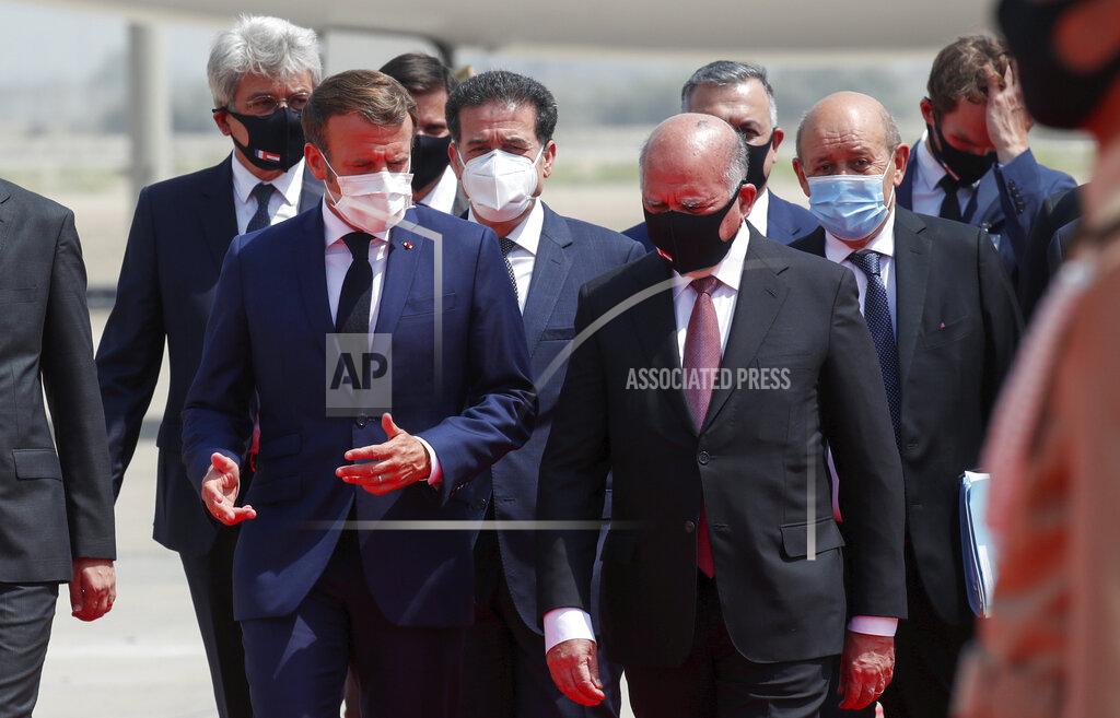 Gonzalo Fuentes French President Emmanuel Macron, left, is welcomed by Iraq's Foreign Minister Fuad Hussein at Baghdad airport, Iraq, Wednesday, Sept. 2, 2020. Macron is the first head of state to visit the Iraqi capital since Prime Minister Mustafa al-Kadhimi, Iraq's former intelligence chief, formed a new government in May. (Gonzalo Fuentes/Pool via AP)