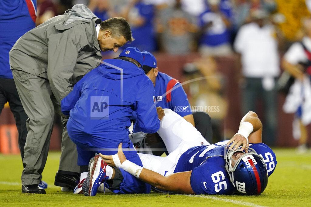 Patrick Semansky New York Giants center Nick Gates (65) lays on the field as members of the team medical staff tend to him during the first half of an NFL football game against the Washington Football Team, Thursday, Sept. 16, 2021, in Landover, Md. Gates sustained an injury on the play and was carted off the field. (AP Photo/Patrick Semansky)