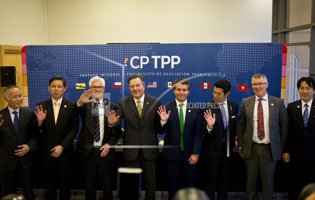 Esteban Felix FILE - In this May 16, 2019, file photo, from left, Vietnam's Deputy Minister of Industry and Trade Tran Quoc Khanh, Singapore's Industry and Trade Minister Chan Chun Sing, Canada's Minister of International Trade Diversification James Carr, Chilean Foreign Minister Fernando Ampuero, Chilean Deputy Minister of Trade Rodrigo Yanez, Japan's Parliamentary Vice Minister of Foreign Affairs Kiyoto Tsuji, New Zealand's Minister for Trade and Export Growth David Parker, and Japan's Parliamentary Vice Minister of Economy, Trade and Industry Akimasa Ishikawa, wave as they pose for the group photo after a meeting of the Comprehensive and Progressive Agreement for Trans-Pacific Partnership, CP TPP, in Santiago, Chile. China has applied to join an 11-nation Asia-Pacific free trade group in an effort to increase its influence over international policies. (AP Photo/Esteban Felix, File)