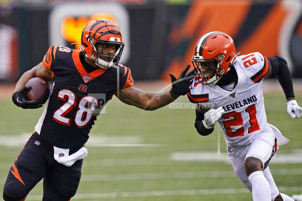 Bryan Woolston Cincinnati Bengals running back Joe Mixon (28) rushes against Cleveland Browns cornerback Denzel Ward (21) during the first half of an NFL football game, Sunday, Dec. 29, 2019, in Cincinnati. (AP Photo/Bryan Woolston)