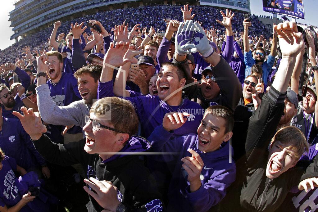Charlie Riedel FILE - Kansas State fans cheer on the field after an NCAA college football game against Oklahoma in Manhattan, Kan., in this Saturday, Oct. 26, 2019, file photo. College football fans will head back into stadiums this weekend, and along with binoculars, sunscreen and other essentials, some will pack facemasks and proof of vaccination.
With the availability of COVID-19 vaccines, the pomp and pageantry of fall Saturdays are expected to return in all their glory nearly everywhere across the country. (AP Photo/Charlie Riedel, File)