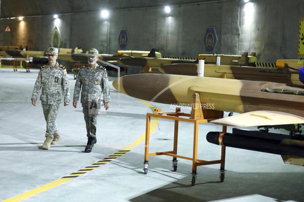 Uncredited In this photo released on Saturday, May 28, 2022 by website of the Iranian Army, Chief of the General Staff of the Armed Forces Gen. Mohammad Hossein Bagheri, left, and Commander of the Army Gen. Abdolrahim Mousavi visit an underground drone base tunnel of the Army in the heart of the country's western Zagros Mountains. Iranian state television's report said Saturday, May 29, the tunnel was some 100 meters (330 feet) underground and was home to the Kaman-22 and Fotros drones, both capable of carrying cruise missiles. (Iranian Army via AP)
