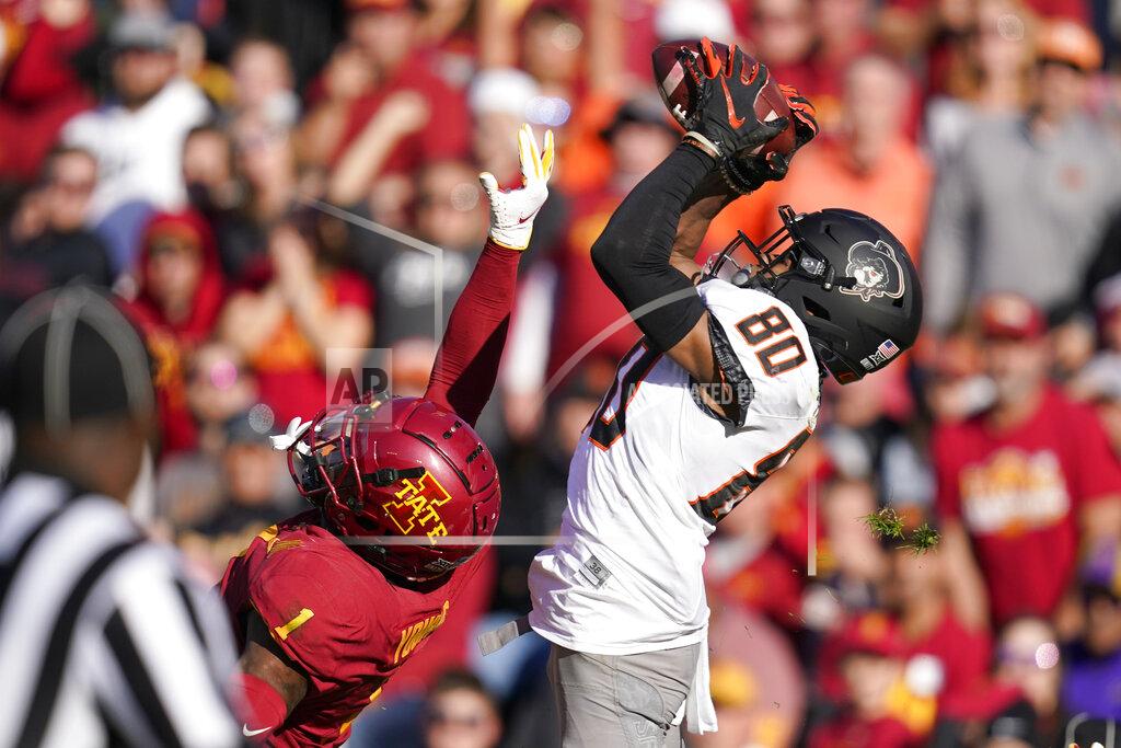 Charlie Neibergall Oklahoma State wide receiver Brennan Presley (80) catches a 42-yard touchdown pass over Iowa State defensive back Isheem Young (1) during the first half of an NCAA college football game, Saturday, Oct. 23, 2021, in Ames, Iowa. (AP Photo/Charlie Neibergall)
