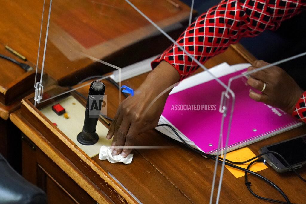 Julio Cortez Maryland Del. Pam Queen, D-Montgomery County, sanitizes her desk prior to the start of the state's 2021 legislative session, Wednesday, Jan. 13, 2021, in Annapolis, Md. (AP Photo/Julio Cortez)