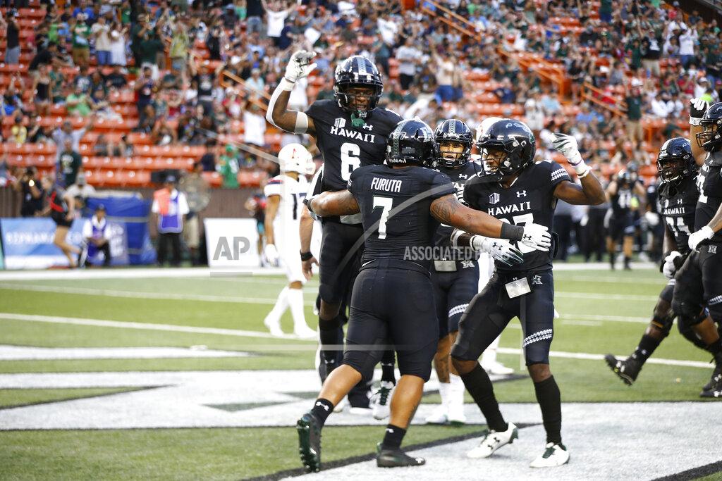Marco Garcia After scoring a second half touchdown, Hawaii running back Dayton Furuta (7) celebrates with his teammates during an NCAA college football game against Arizona, Saturday, Aug. 24, 2019, in Honolulu. (AP Photo/Marco Garcia)