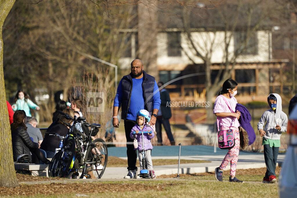 Nam Y. Huh People enjoy the mild weather at the Burning Bush Trails park in Mount Prospect, Ill., Saturday, March 13, 2021. Illinois Gov. J.B. Pritzker announced on Friday that all Illinois adults could be eligible for a coronavirus vaccine before May. (AP Photo/Nam Y. Huh)