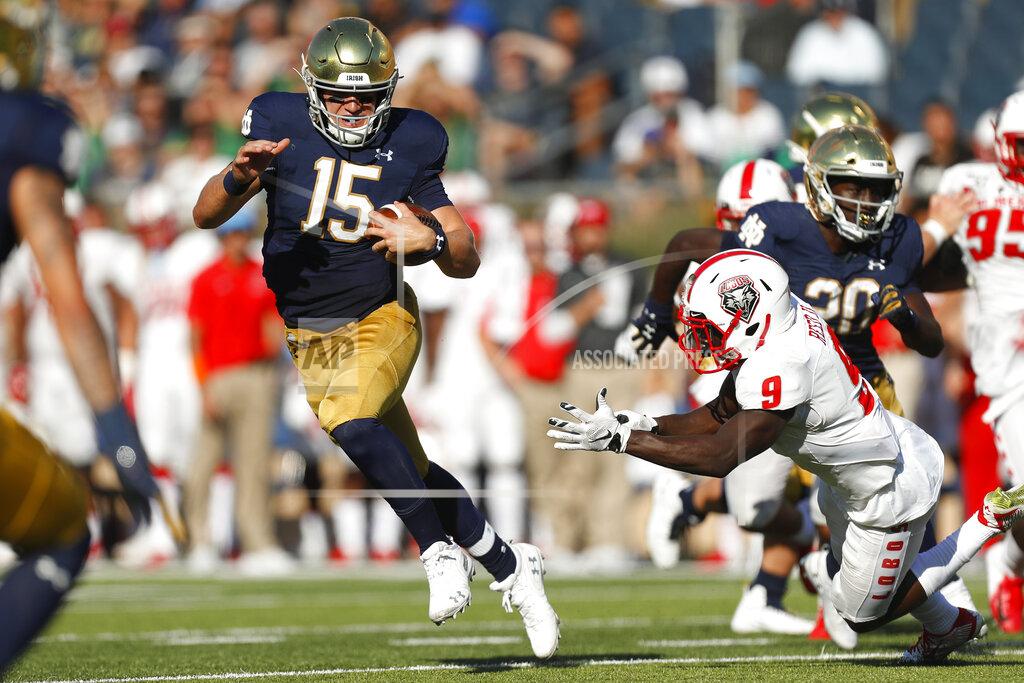 Paul Sancya Notre Dame quarterback Phil Jurkovec (15) avoids New Mexico safety Jerrick Reed II (9) in the second half of an NCAA college football game in South Bend, Ind., Saturday, Sept. 14, 2019. (AP Photo/Paul Sancya)