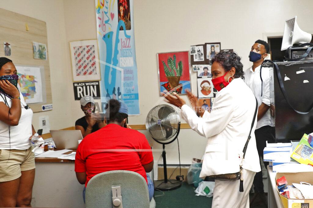 Kathy Willens U.S. Rep. Yvette Clarke, D-N.Y., foreground right, applauds her campaign workers and volunteers, in her campaign headquarters, Tuesday, June 23, 2020, in the Brooklyn borough of New York, as results for New York state's delayed primary election continued to be tabulated. The election was postponed because of the coronavirus outbreak. Due to a large number of people who opted to vote absentee, accurate and complete election results will be delayed, as well. (AP Photo/Kathy Willens)
