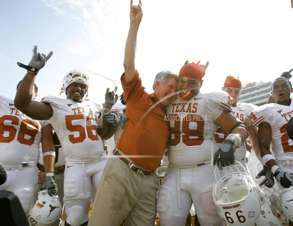 Tony Gutierrez FILE - In this Oct. 11, 2008, file photo, Texas coach Mack Brown celebrates with Texas defensive tackle Roy Miller (99) and others after beating No. 1 Oklahoma 45-35 in an NCAA college football game, in Dallas. The annual Texas-Oklahoma rivalry game in Dallas decided the Big 12 more often than not. Both teams were nationally ranked in nine of the ten meetings. Oklahoma won the first five from 2000-04 but Texas bounced back by winning four of the last five. (AP Photo/Tony Gutierrez, File)