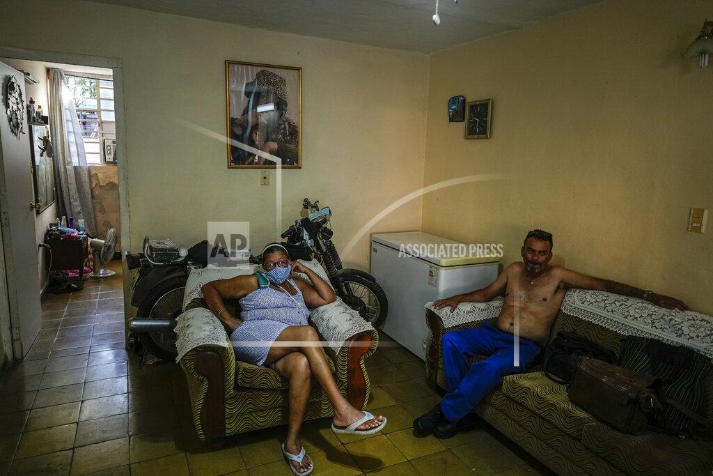 Ramon Espinosa Carmen Morales and her son Angel Rodriguez sit at home in the BahÌa neighborhood in Havana, Cuba, Wednesday, May 18, 2022. Rodriguez's wife, Marylin Alvarez, began transforming part of her house into a tiny cafe with the help of money sent by a cousin living in the U.S. during President Barack Obama's administration, but it fell apart when President Donald Trump's administration tightened the embargo and sharply restricted money transfers to Cuba in late 2020, which turned Alvarez to a less costly form of making money for her family — giving manicures. (AP Photo/Ramon Espinosa)