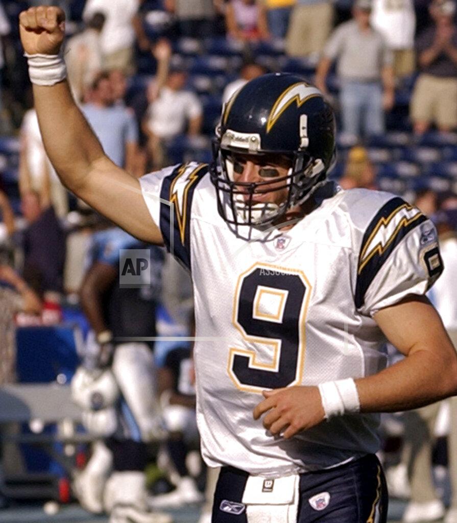 Denis Poroy File-This Oct. 3, 2004, file photo shows San Diego Chargers quarterback Drew Brees pumping his fist as the Chargers score another touchdown in the fourth quarter of their 38-17 victory over the Tennessee Titans in San Diego. Brees, the NFL’s leader in career completions and yards passing, has decided to retire after 20 NFL seasons, including his last 15 with New Orleans. (AP Photo/Denis Poroy, File)