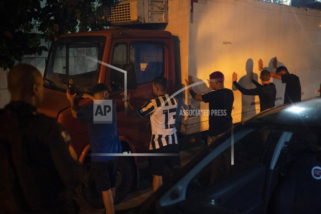 Felipe Dana People arriving for a party are checked by police officers during an operation against COVID-19 restriction violations in Rio de Janeiro, Brazil, late Saturday, April 3, 2021. (AP Photo/Felipe Dana)