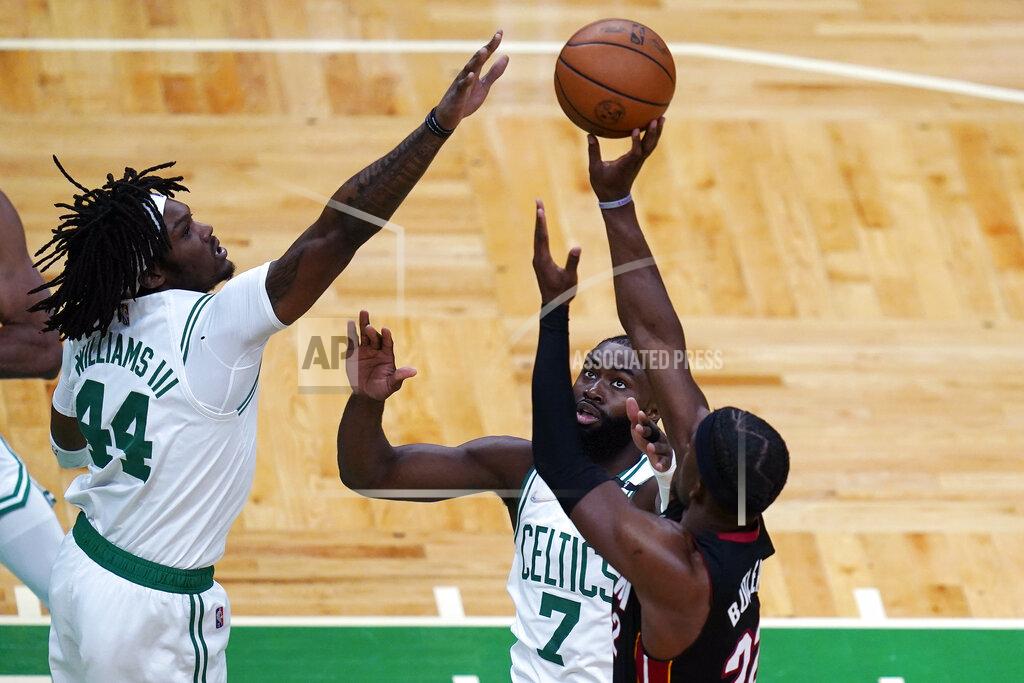 Charles Krupa Boston Celtics center Robert Williams III (44) tries to block a shot by Miami Heat forward Jimmy Butler, right, during the first half of Game 4 of the NBA basketball playoffs Eastern Conference finals, Monday, May 23, 2022, in Boston. Celtics guard Jaylen Brown (7) looks on. (AP Photo/Charles Krupa)