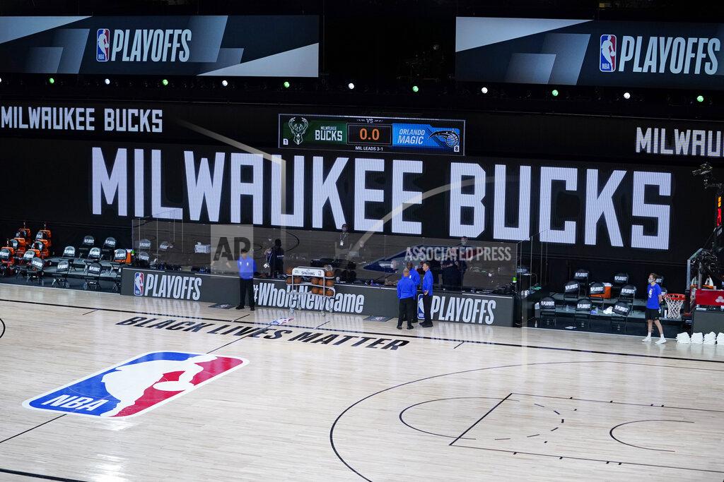 Ashley Landis Officials stand beside an empty court at the scheduled start of an NBA basketball first round playoff game between the Milwaukee Bucks and the Orlando Magic, Wednesday, Aug. 26, 2020, in Lake Buena Vista, Fla. The Milwaukee Bucks didn't take the floor in protest against racial injustice and the shooting of Jacob Blake, a Black man, by police in Kenosha, Wisconsin. (AP Photo/Ashley Landis, Pool)
