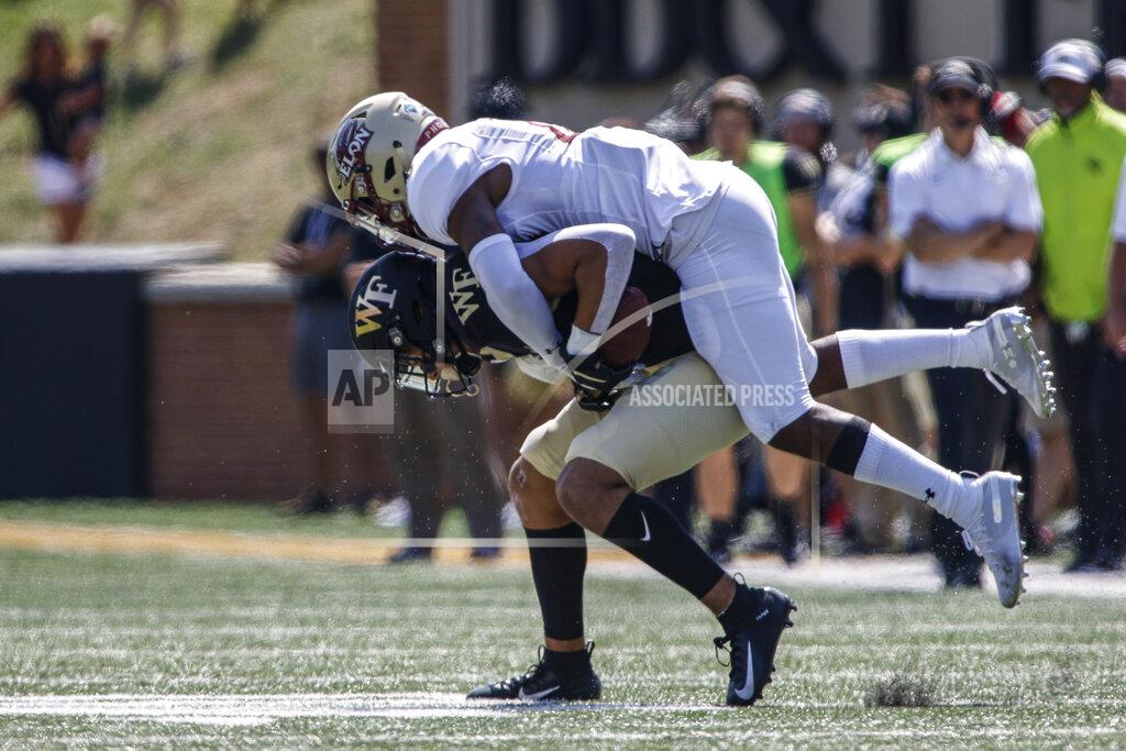 Nell Redmond Wake Forest wide receiver Sage Surratt, left, keeps his balance as fights for yards as Elon defensive back Daniel Reid-Bennett tries to make the tackle in the first half of an NCAA college football game in Winston-Salem, N.C., Saturday, Sept. 21, 2019. (AP Photo/Nell Redmond)
