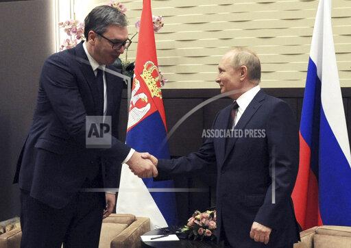 Russian President Vladimir Putin, right, and Serbian President Aleksandar Vucic shake hands during their meeting in Sochi, Russia, Thursday, Nov. 25, 2021. (Mikhail Klimentyev, Sputnik, Kremlin Pool Photo via AP)