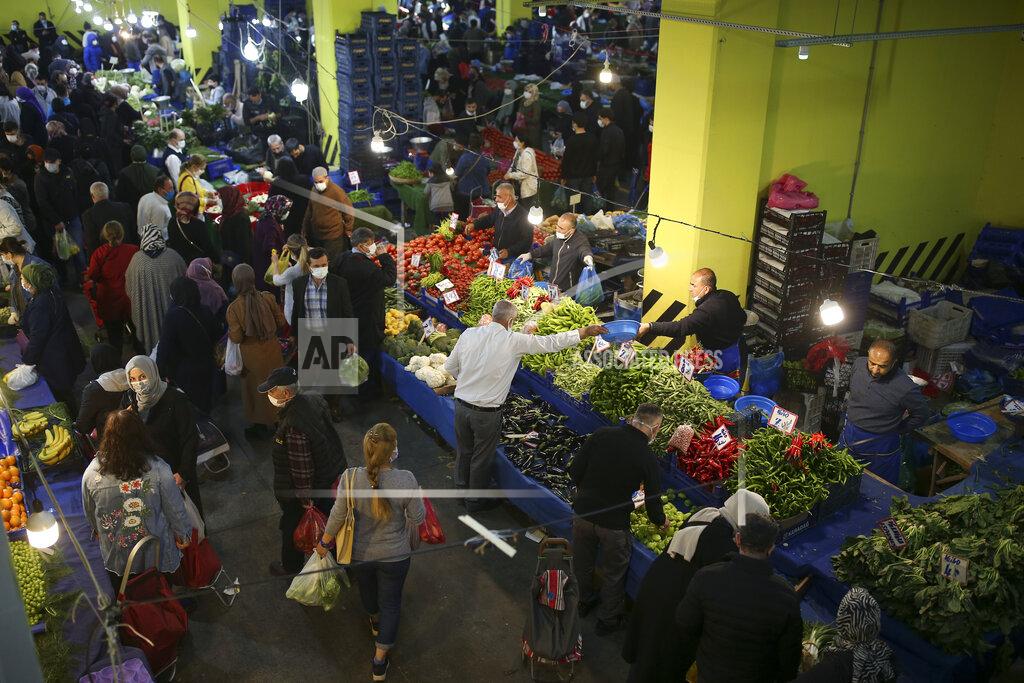 Emrah Gurel People shop at the local market in Istanbul, Thursday, April 29, 2021, a few hours before the start of the latest lockdown to help protect from the spread of the coronavirus. People stocked up on groceries, shoppers filled markets and many left cities for their hometowns or the southern coast as Turkey's strictest COVID-19 lockdown yet came into effect late Thursday. President Recep Tayyip Erdogan imposed a "full lockdown" until May 17 amid soaring COVID-19 infections and deaths. Turkey now ranks among the world's worst-hit countries and it's the first time that it is imposing a nearly three-week lockdown for the whole of the country. (AP Photo/Emrah Gurel)
