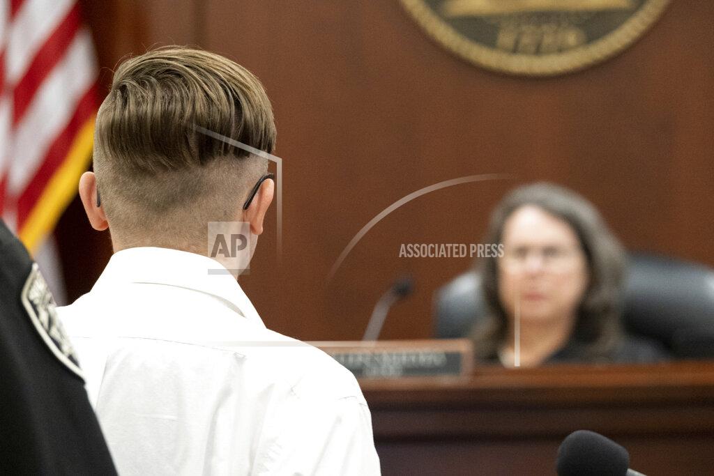Ben Gray Defendant Robert Aaron Long stands before Judge Ellen McElyea during a plea hearing in Superior Court of Cherokee County in Canton, Ga., Tuesday, July 27, 2021. Long, accused of killing eight people, most of them women of Asian descent, at Atlanta-area massage businesses pleaded guilty to four of the murders. He was handed four sentences of life without parole. (Ben Gray/Atlanta Journal-Constitution via AP, Pool)