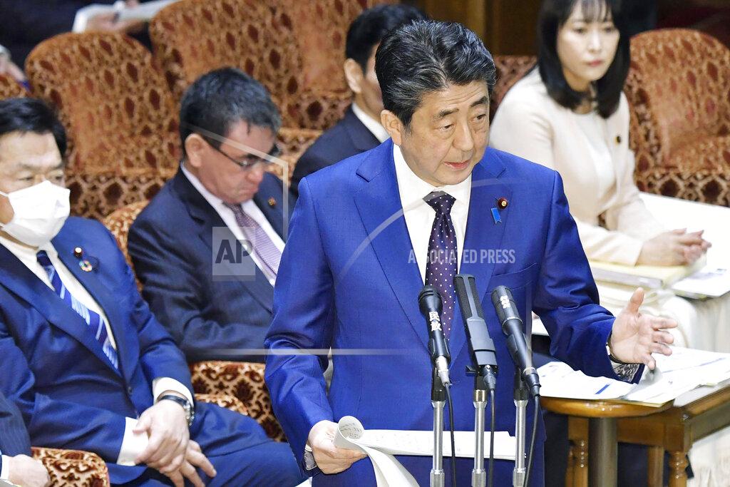 Yoshitaka Sugawara Japan’s Prime Minister Shinzo Abe speaks at a parliamentary session in Tokyo Monday, March 23, 2020. Abe said a postponement of Tokyo Olympics would be unavoidable if the games cannot be held in a complete way because of the coronavirus pandemic. (Yoshitaka Sugawara/Kyodo News via AP)