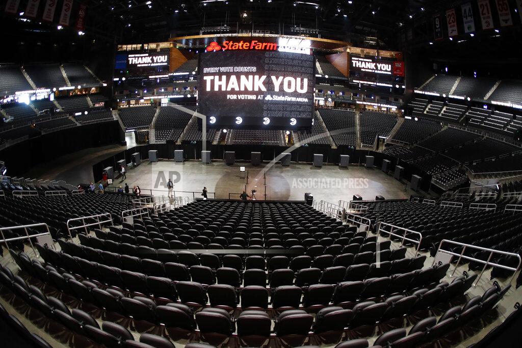 John Bazemore Voting machines are lined up on the floor of State Farm Arena, home of the NBA's Atlanta Hawks basketball team, Friday, July 17, 2020, in Atlanta. The 16,888-seat facility will be used as a poll location for the upcoming election. (AP Photo/John Bazemore)