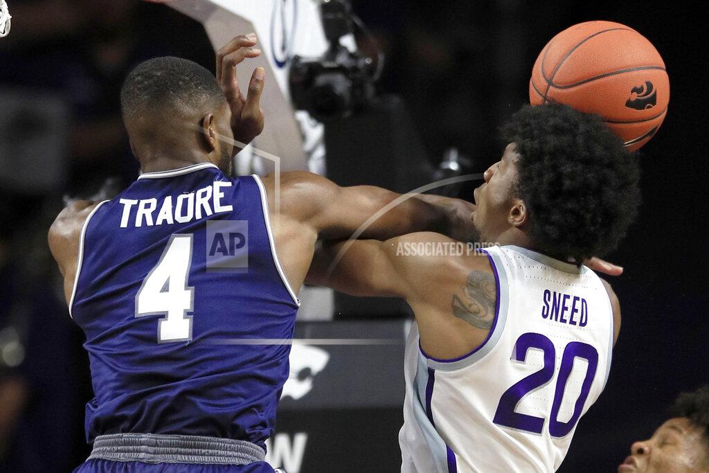 Orlin Wagner Kansas State forward Xavier Sneed (20) is fouled by Monmouth forward Mustapha Traore (4) during the first half of an NCAA college basketball game in Manhattan, Kan., Wednesday, Nov. 13, 2019. (AP Photo/Orlin Wagner)