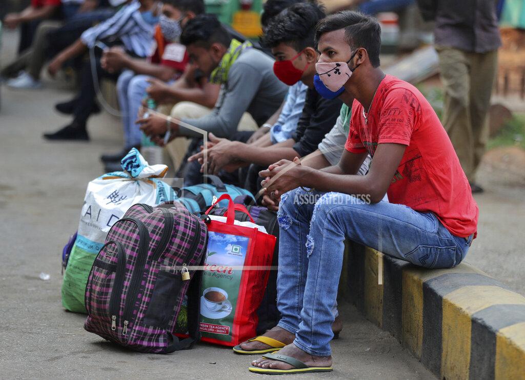 Aijaz Rahi Travelers wait for outstation trains after authorities imposed a two-week lockdown to curb the rising number of COVID-19 cases in Bengaluru, India, Wednesday, April 28, 2021. India, a country of nearly 1.4 billion people, Wednesday became the fourth nation to cross 200,000 deaths. (AP Photo/Aijaz Rahi)