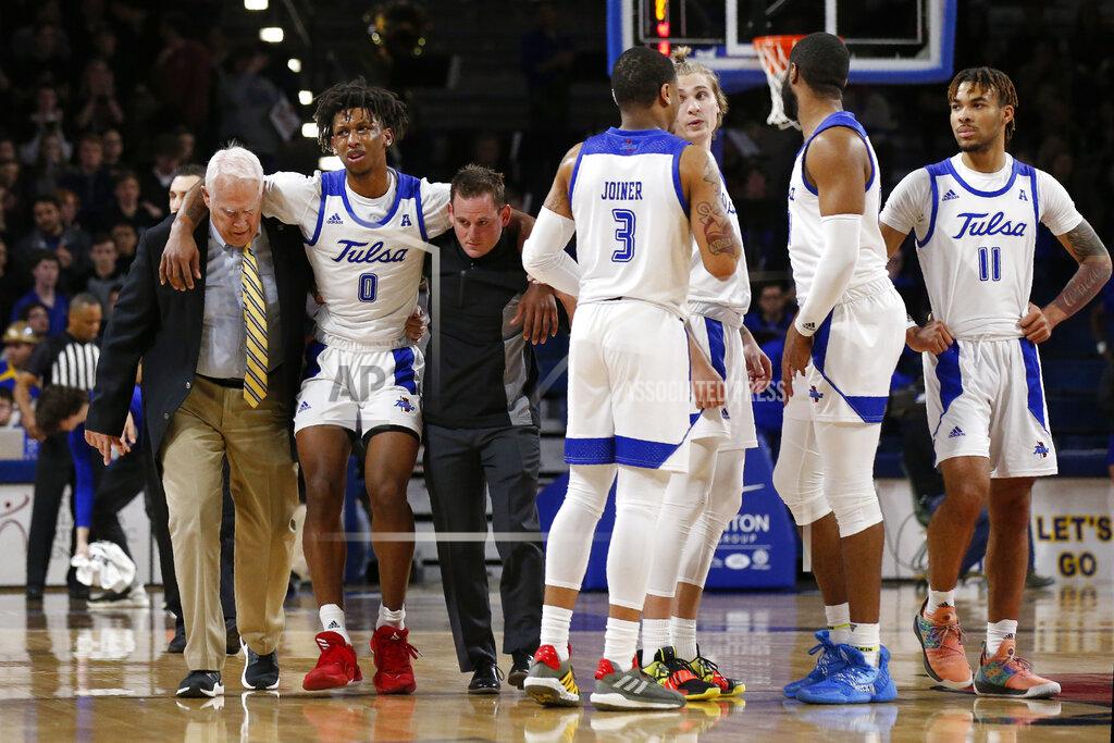 Sue Ogrocki Tulsa guard Brandon Rachal (0) is helped off the court following an injury during the second half of the team's NCAA college basketball game against Connecticut in Tulsa, Okla., Thursday, Feb. 6, 2020. (AP Photo/Sue Ogrocki)