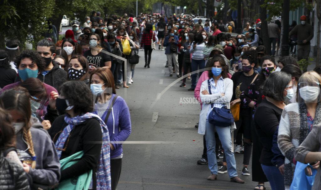 Esteban Felix People line up for their turn to vote during a referendum to decide whether the country should replace its 40-year-old constitution, in Santiago, Chile, Sunday, Oct. 25, 2020.(AP Photo/Esteban Felix)