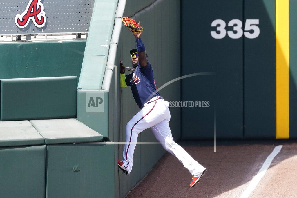 John Bazemore Atlanta Braves left fielder Marcell Ozuna (20) makes a catch in foul territory to retire Minnesota Twins' Luis Arraez in the fourth inning of a spring training baseball game, Friday, March 5, 2021, in North Port, Fla. (AP Photo/John Bazemore)