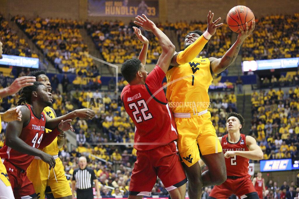 Kathleen Batten West Virginia forward Derek Culver (1) goes to shoot as he is defended by Texas Tech forward TJ Holyfield (22) during the second half of an NCAA college basketball game Saturday, Jan. 11, 2020, in Morgantown, W.Va. (AP Photo/Kathleen Batten)
