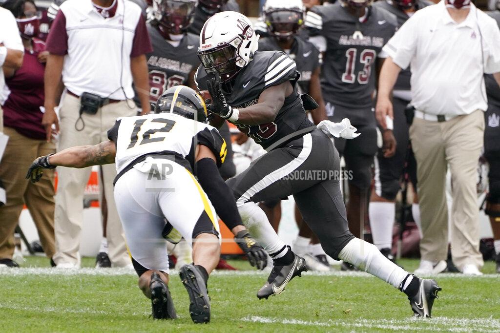 Rogelio V. Solis Alabama A&M running back Gary Quarles (23) fights off a tackle attempt by Arkansas-Pine Bluff defensive back Shawn Steele (12) during the second half of the Southwestern Athletic Conference championship NCAA college football game Saturday, May 1, 2021, in Jackson, Miss. Alabama A&M won 40-33. (AP Photo/Rogelio V. Solis)