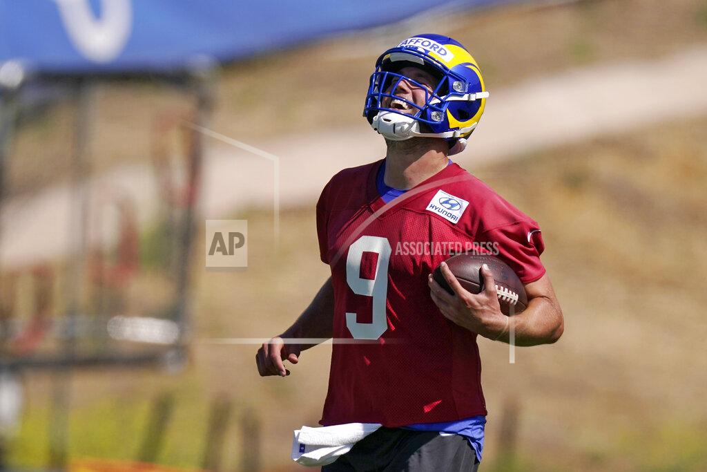 Mark J. Terrill Los Angeles Rams quarterback Matthew Stafford laughs as he runs the ball during an NFL mini camp football practice Tuesday, June 7, 2022, in Thousand Oaks, Calif. (AP Photo/Mark J. Terrill)
