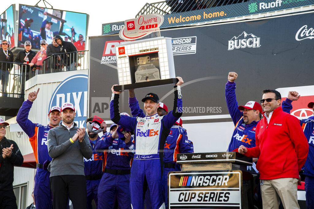 Mike Caudill Denny Hamlin raises the trophy after winning the NASCAR Cup Series auto race at Richmond Raceway on Sunday, April 3, 2022, in Richmond, Va. (AP Photo/Mike Caudill)