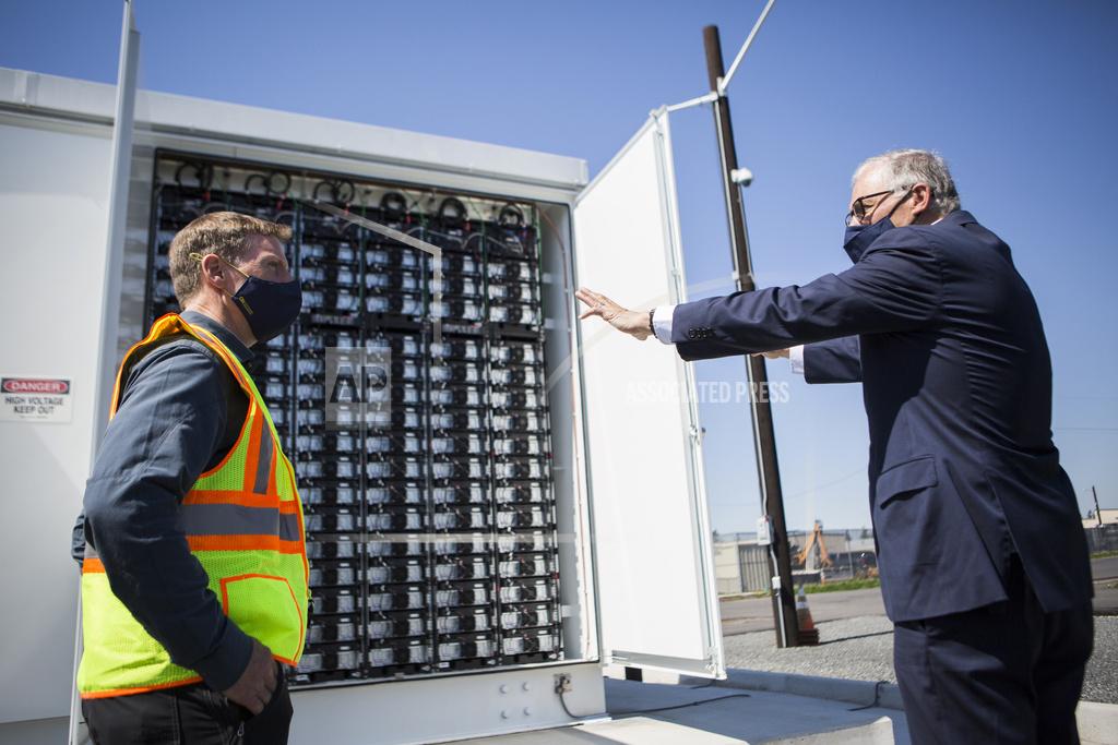 Olivia Vanni Gov. Jay Inslee, right, speaks to principal engineer Scott Gibson about the Microgrid batteries Tuesday, April 20, 2021, in Arlington, Wash. (Olivia Vanni/The Herald via AP)