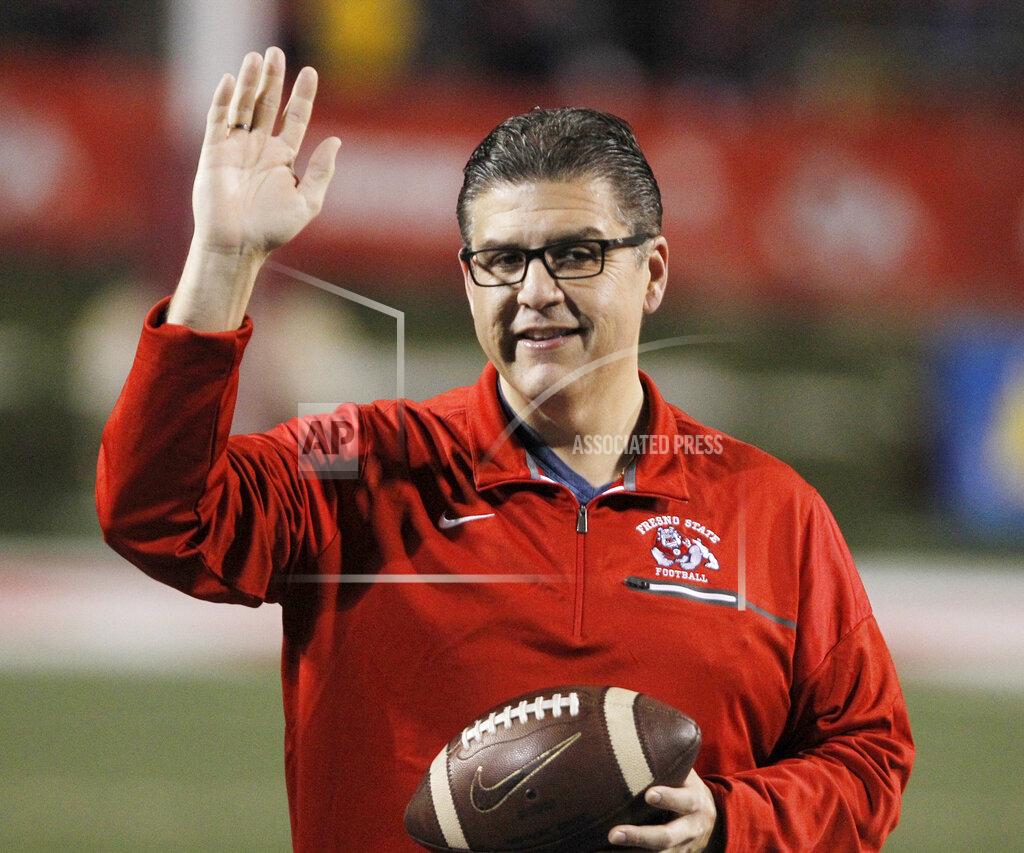 FILE - In this Nov. 4, 2017 file photo, Fresno State president Joseph I. Castro waves to the crowd before an NCAA college football game against BYU in Fresno, Calif. Castro was chosen to be the new chancellor of the California State University, becoming the first Mexican-American and native Californian to lead the nation's largest four-year public university system. The CSU Board of Trustees announced the appointment of Castro on Wednesday, Sept. 23, 2020. He will replace Chancellor Timothy White, who is retiring. (AP Photo/Gary Kazanjian, File)