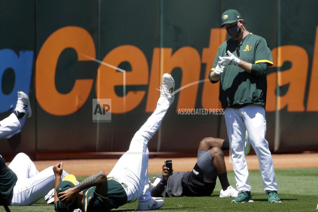 Jeff Chiu Oakland Athletics pitching coach Scott Emerson, right, talks to players during a baseball practice in Oakland, Calif., Saturday, July 4, 2020. (AP Photo/Jeff Chiu)