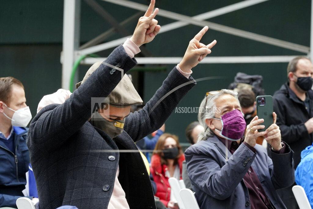 Richard Drew Actor Lin-Manuel Miranda, left, and his father, Luis A. Miranda, Jr., watch a musical performance in Times Square after they toured the grand opening of a Broadway COVID-19 vaccination site intended to jump-start the city's entertainment industry, in New York, Monday, April 12, 2021. (AP Photo/Richard Drew)