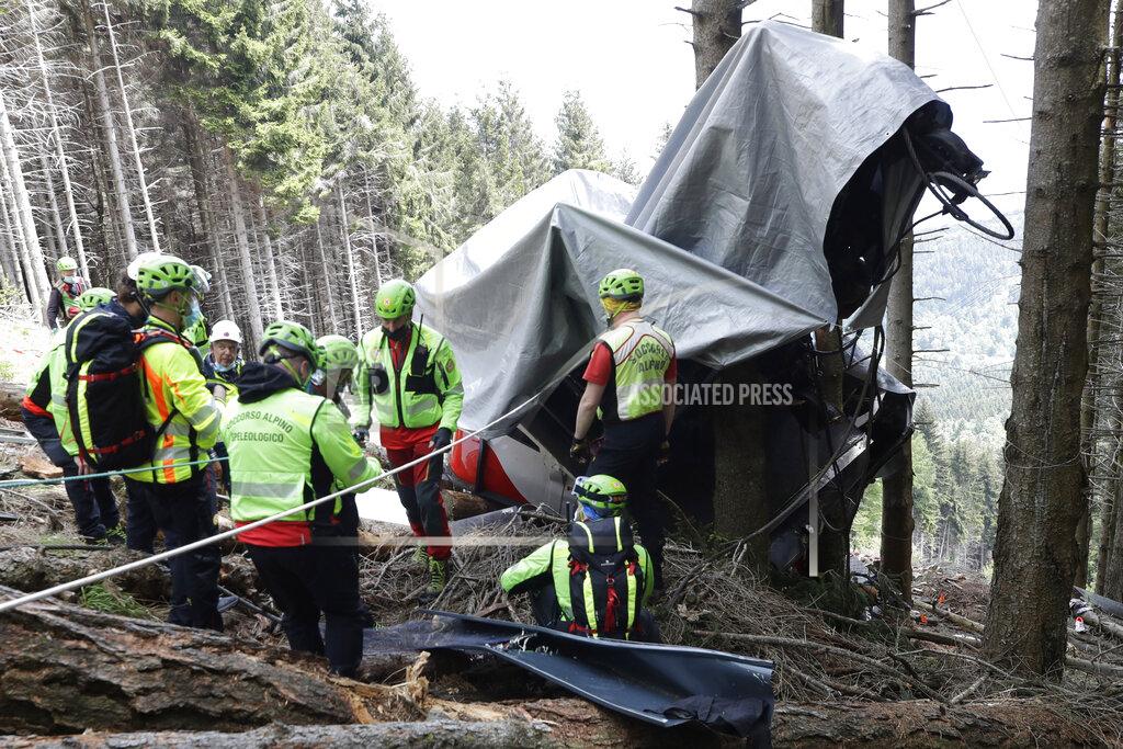 Luca Bruno Rescuers search for evidence in the wreckage of a cable car after it collapsed near the summit of the Stresa-Mottarone line in the Piedmont region, northern Italy, Wednesday, May 26, 2021. Police have made three arrests in the cable car disaster that killed 14 people after an investigation showed a clamp, placed on the brake as a patchwork repair effort, prevented the brake from engaging after the lead cable snapped. (AP Photo/Luca Bruno)