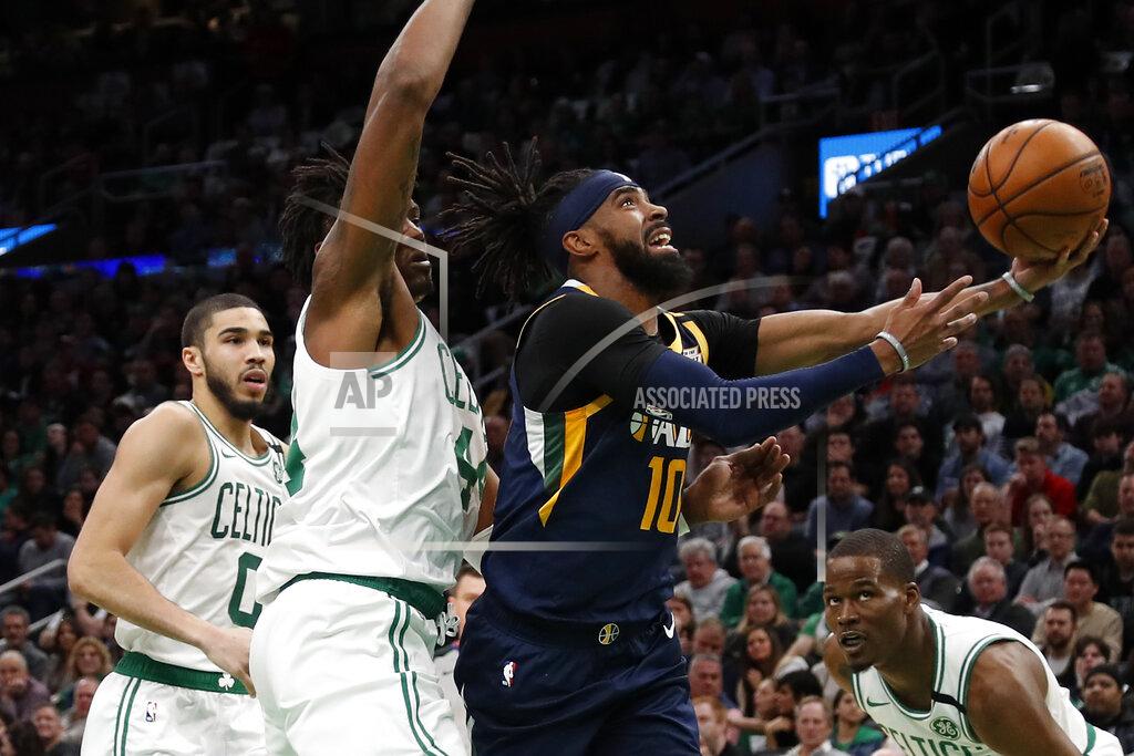 Winslow Townson Utah Jazz's Mike Conley (10) goes to the basket past Boston Celtics' Robert Williams III during the first quarter of an NBA basketball game Friday, March 6, 2020, in Boston. (AP Photo/Winslow Townson)